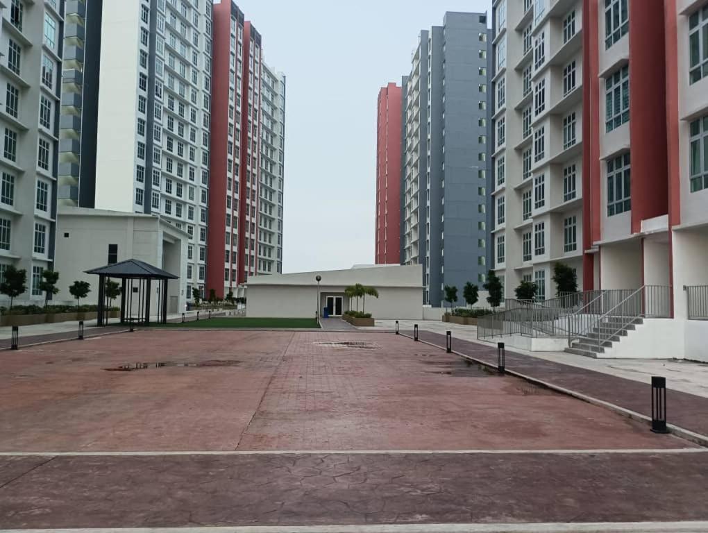 an empty parking lot in a city with tall buildings at zamanss homestay in Kampong Simee