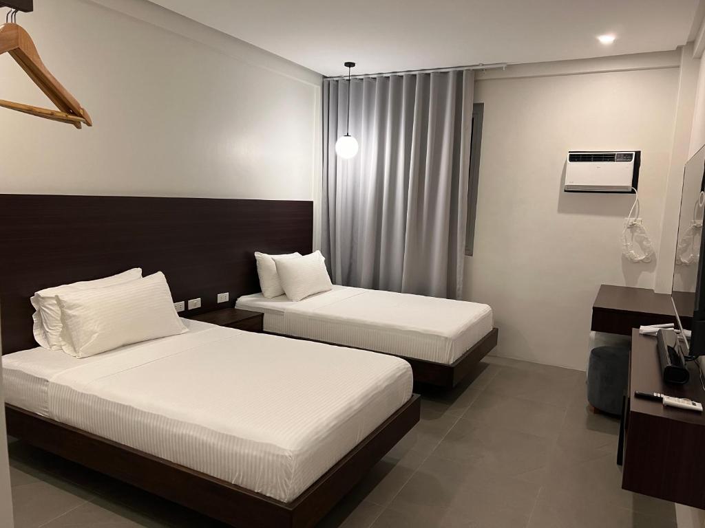 Postel nebo postele na pokoji v ubytování Joane Suites by Hotel Cara