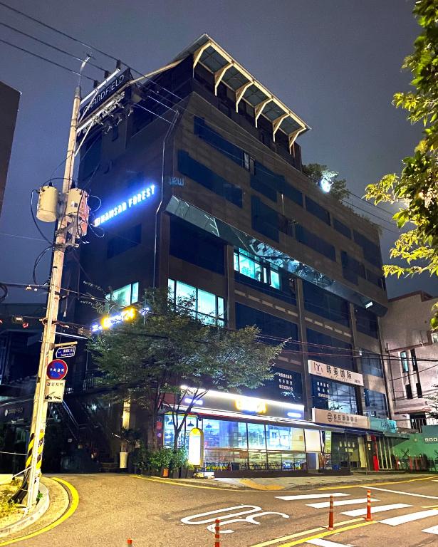 a large building with lights on it at night at Namsan Forest in Myeongdong in Seoul
