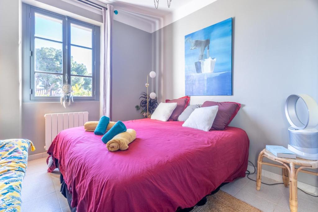 a bedroom with a large pink bed with a teddy bear on it at Le Terra'Ciel - Ciotat in La Ciotat