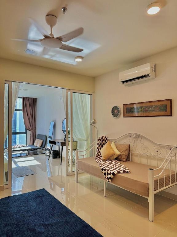 a living room with a couch and a ceiling fan at The Shore Kota Kinabalu by Daisy Suites in Kota Kinabalu