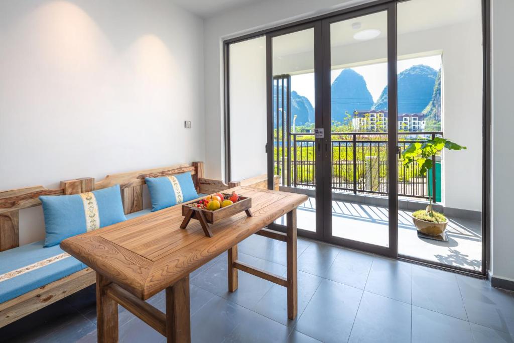 a living room with a couch and a wooden table at Phoenix Tree Lodge in Fuli