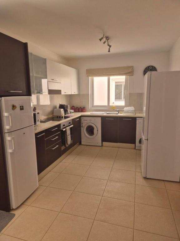 a kitchen with a white refrigerator and a dishwasher at 3 Bedroom property in Paradise Beach in Santa Maria