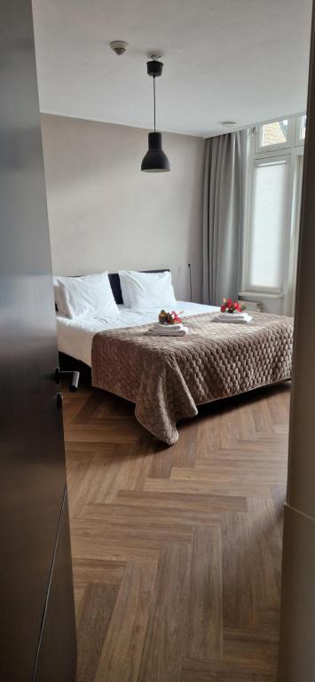 Postel nebo postele na pokoji v ubytování Apart Hotel De Grote Kade