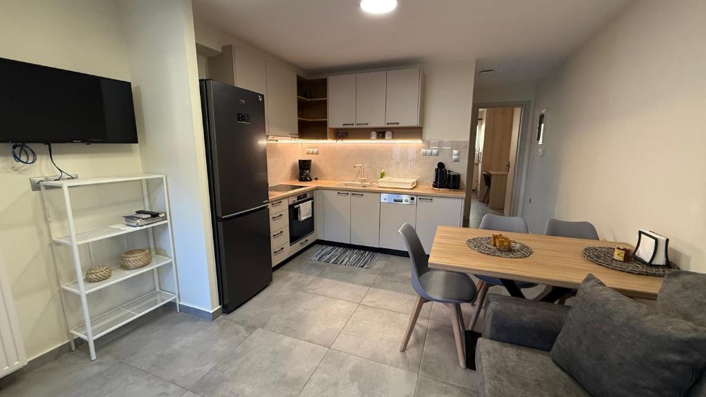 a kitchen and dining room with a table and chairs at Leonidio Apartment Zenith-Nadir in Leonidion