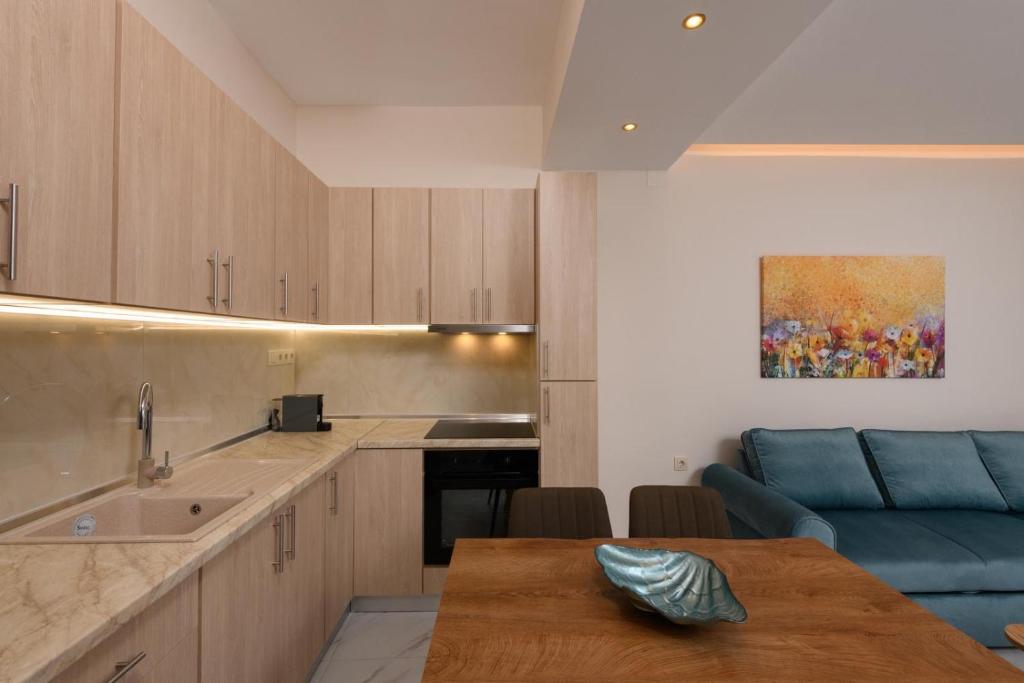a kitchen with a table and a blue couch at Ninemia House in Limenas