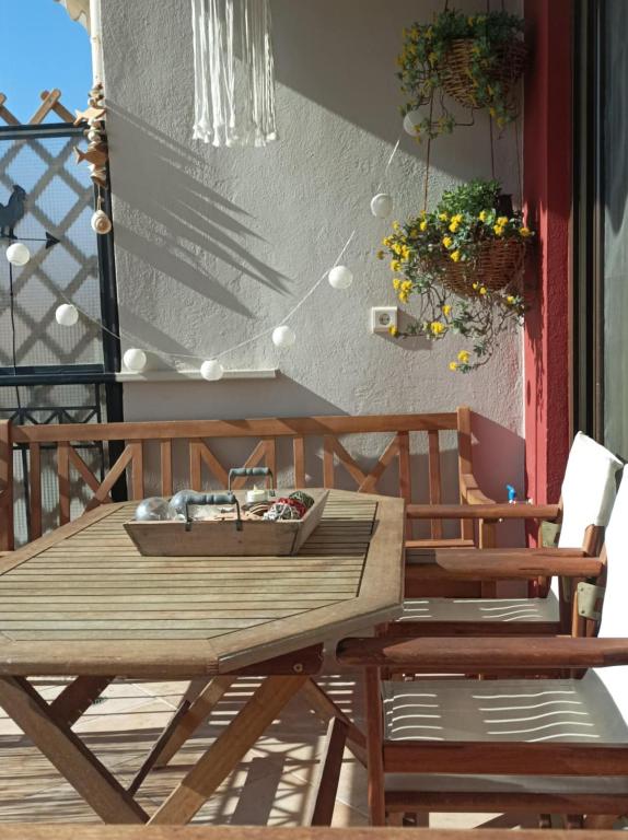 a wooden table and chairs on a patio at Breathe in Delphi - Spacious 3BR Apt with View in Delphi