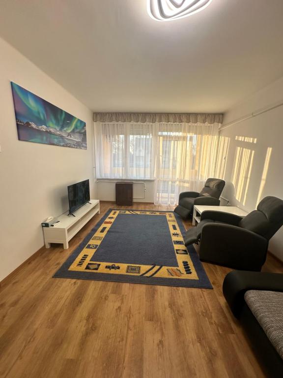 a living room with a couch and a tv at Bende-lak in Nyíregyháza