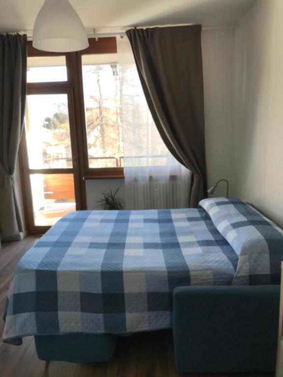 Postel nebo postele na pokoji v ubytování Monolocale a Torre Pellice