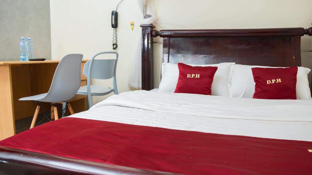 Postel nebo postele na pokoji v ubytování Hotel Deposh Tororo