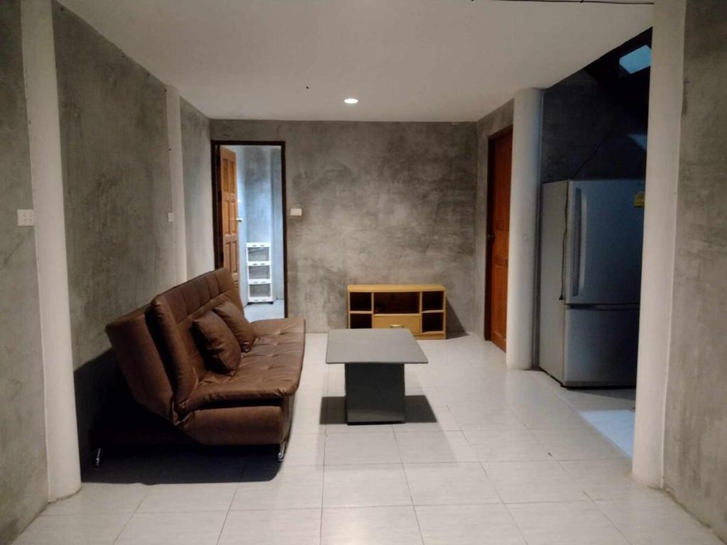 a living room with a couch and a table at Loft House 3 Bedrooms in Pai