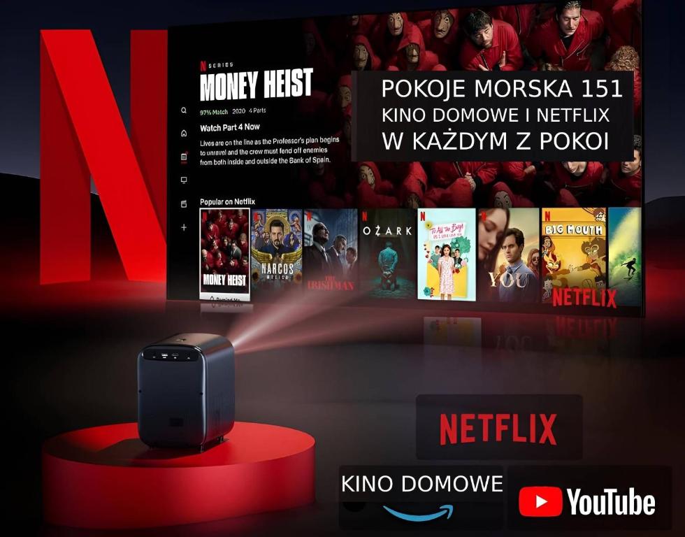 a tv with a speaker on a red table in front of a tv screen at Morska Aqua Massage Room 1 in Gdynia