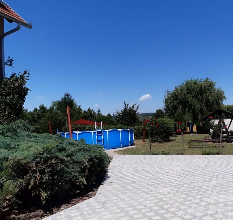 a park with blue trash cans in the background at Gyöngy-ház Balaton, önálló nyaraló in Szőlősgyörök