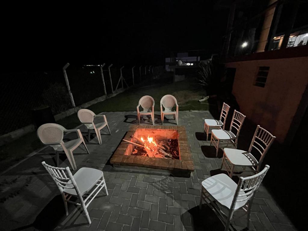 a group of chairs around a fire pit at night at Rancho Celebrai in Caçapava
