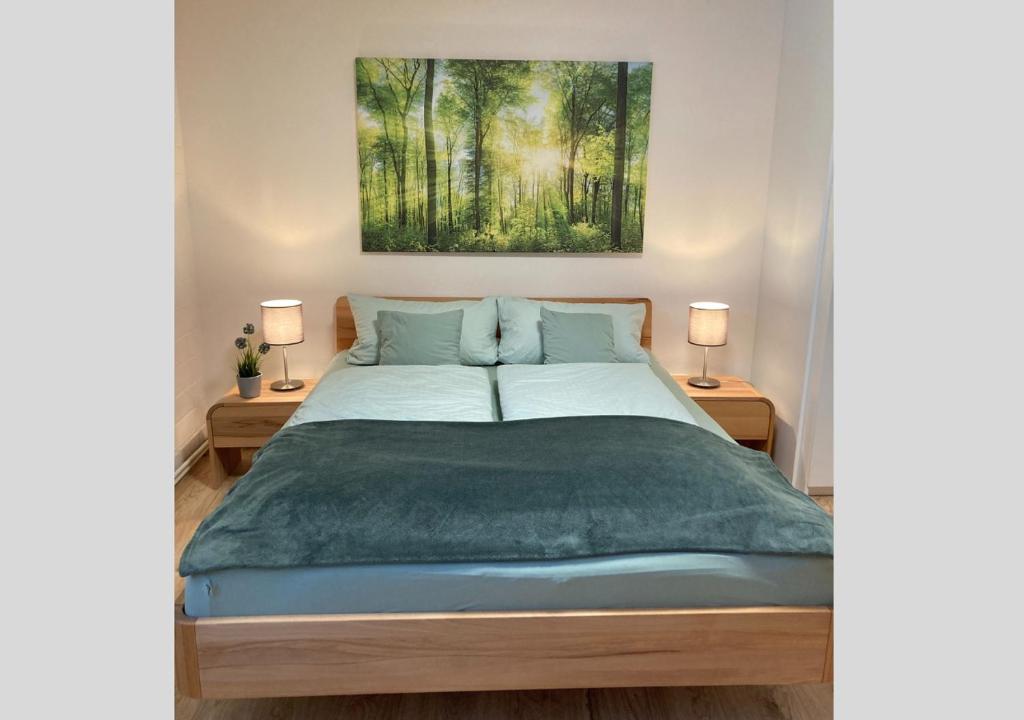 a bedroom with a bed with a painting on the wall at Hecht Ferienvermietung - Fewo Turmfalke 2-Zimmer-Appartement mit Sauna und Schwimmbad in Sankt Englmar