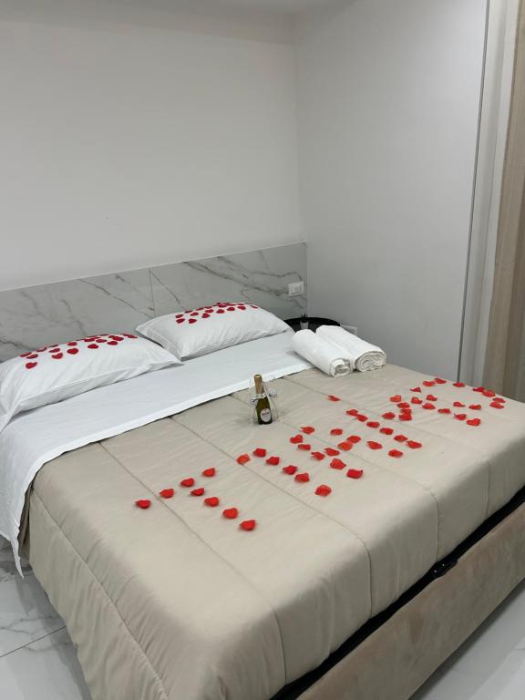 a bed with red roses laid out on it at Emerald Rooms in Naples