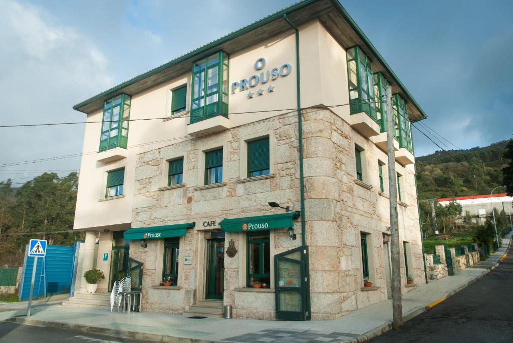 a building on the corner of a street at Pensión O Prouso in Carnota