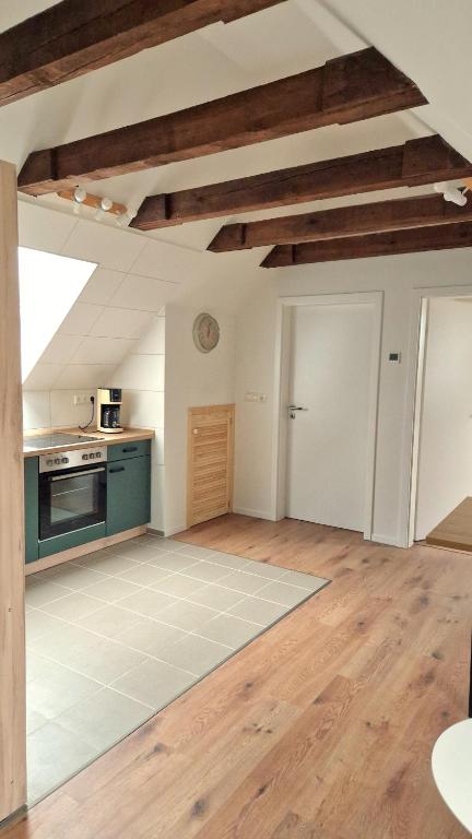 a large kitchen with wooden floors and wooden ceilings at Central apartment in Buchholz idN in Buchholz in der Nordheide