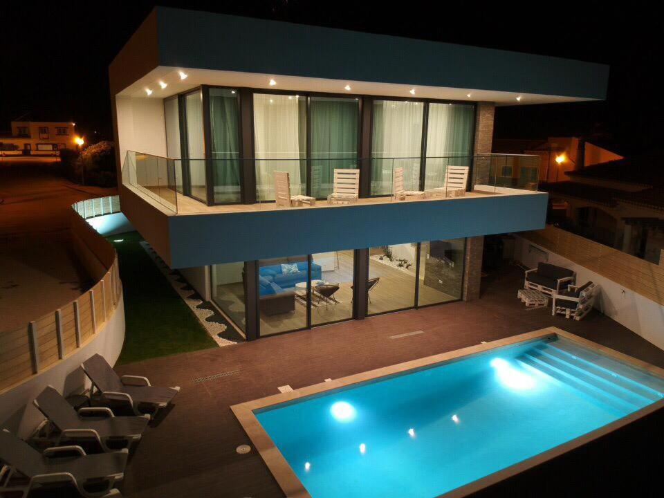 a large house with a swimming pool in front of it at Sunrise Villa in Sagres