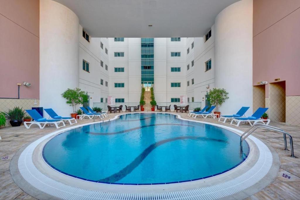 a pool in the middle of a hotel lobby at Tabs Dubai Hostel in Dubai
