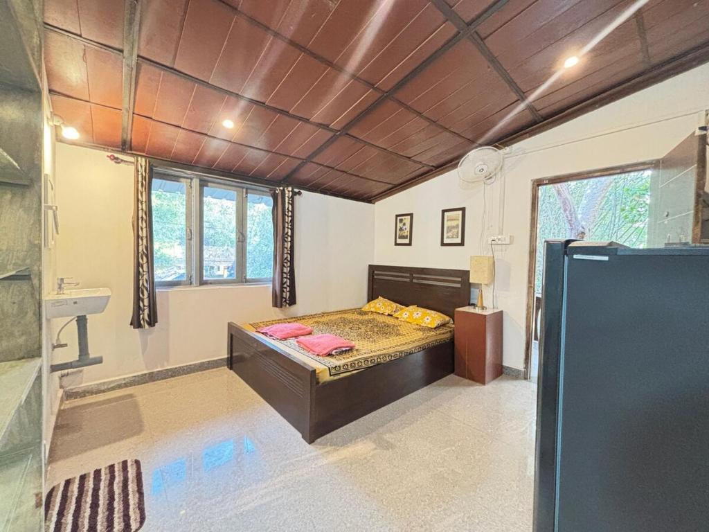 a bedroom with a bed in the middle of a room at Studio Arambol Escape R-8 by Mukund Sadan Arambol in Arambol