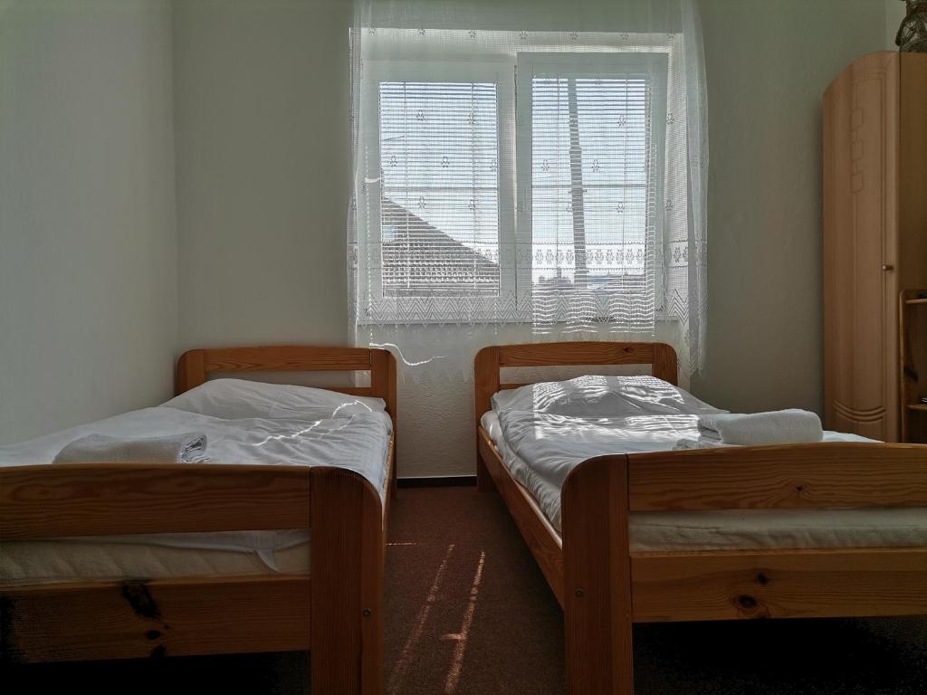Postel nebo postele na pokoji v ubytování Penzion pod Kostelíčkem