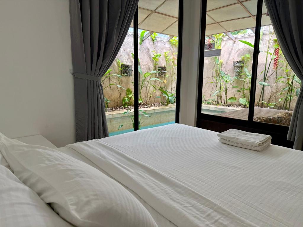 a white bed in a room with a window at Ardour Lodge "B" Wing in George Town