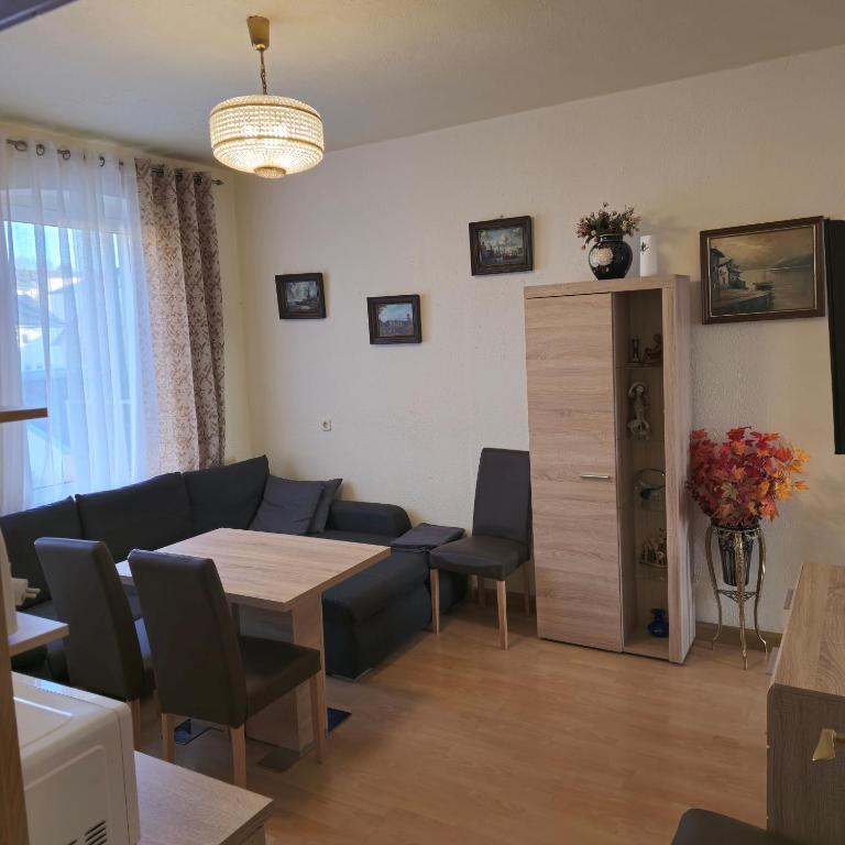 a living room with a couch and a table and chairs at Apartment 5 in Gera