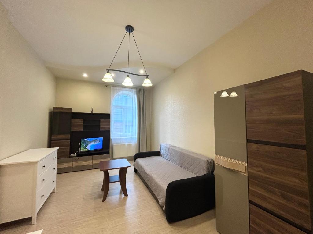 a living room with a couch and a tv at OLD TOWN Republika - 2 rooms - Self Check In - 24 hours - Free parking in Liepāja