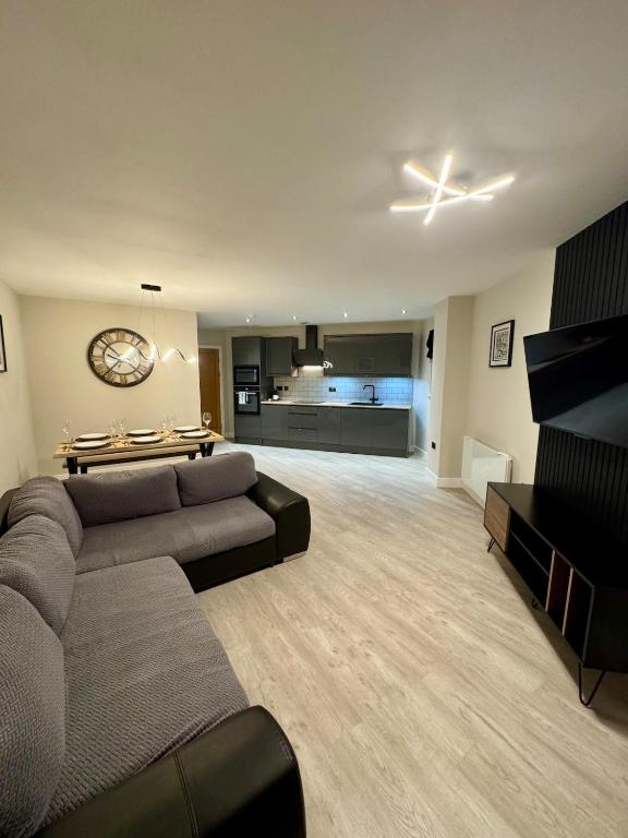 a large living room with a couch and a table at 267 Stylish 2 Bed Apartment City Centre Free Parking in Cardiff