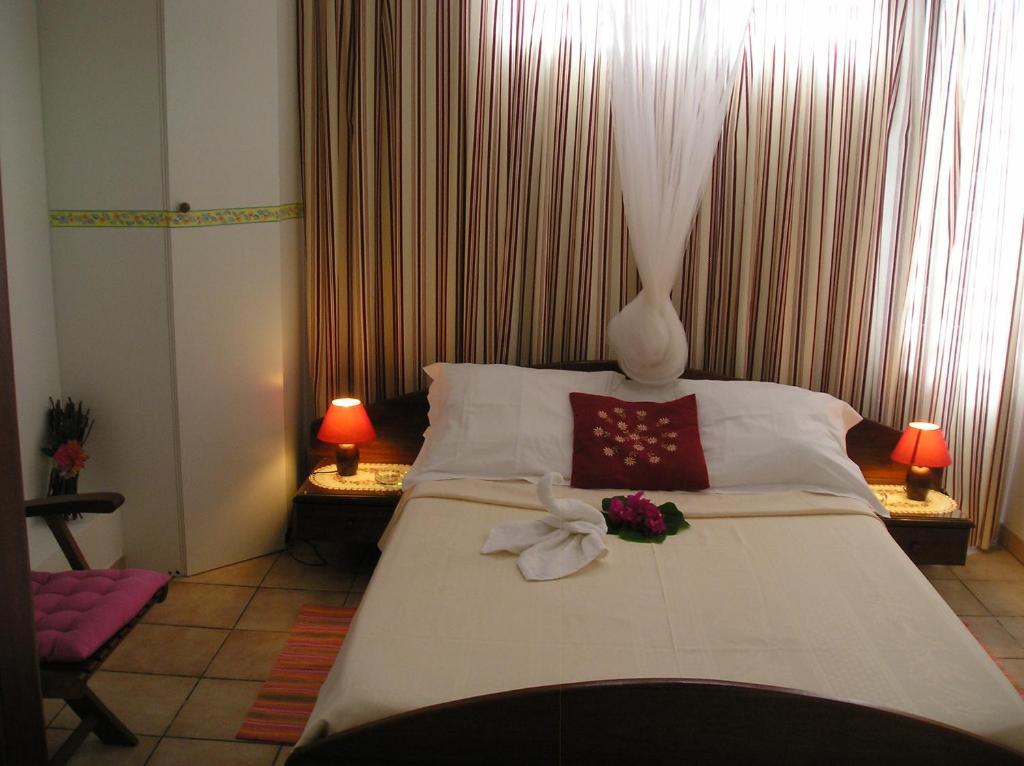 a bedroom with a large bed with flowers on it at L'escapade in Sainte-Anne