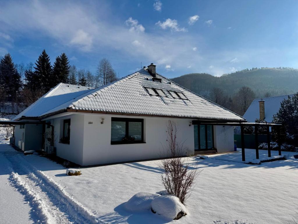 a white house with snow on the ground at Bystra 150 in Bystrá
