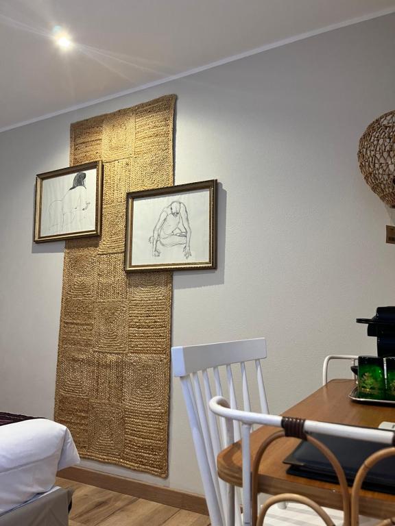 a dining room with two pictures on the wall at Irin Hotel in Antibes
