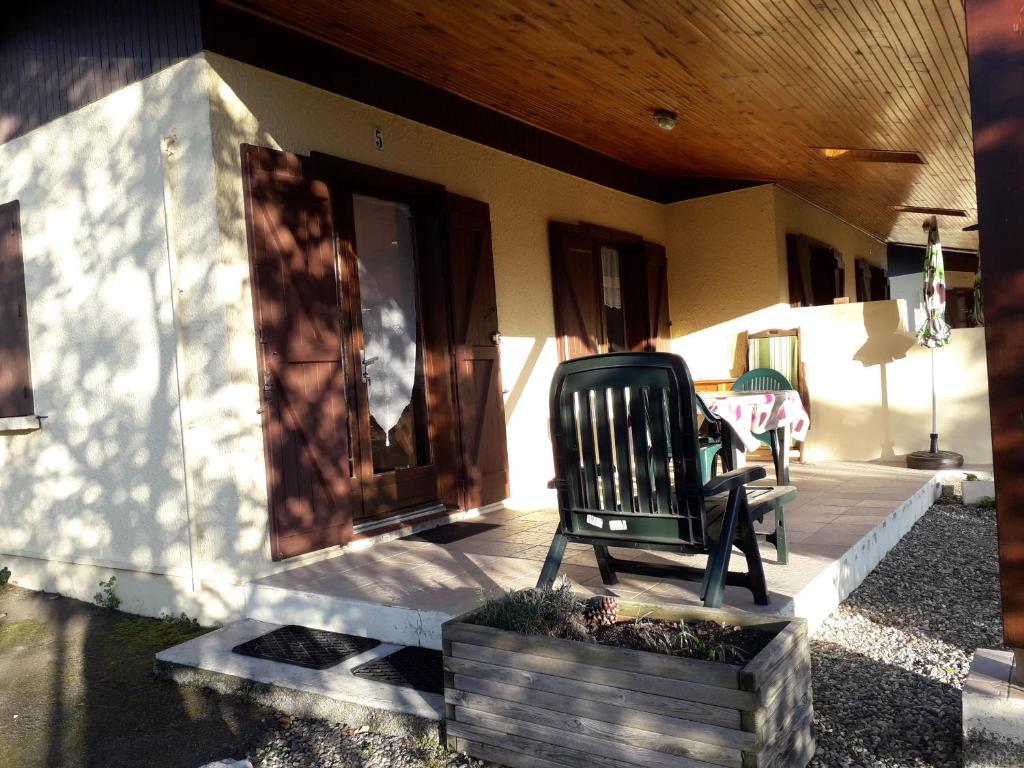 a rocking chair sitting on the porch of a house at MF n 7 in Cazaubon