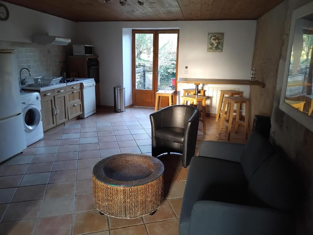 a living room with a couch and a table at Le Courcelot in Saint-Loup-sur-Aujon