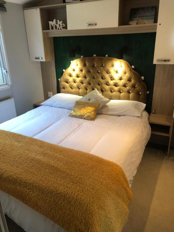 a bedroom with a large bed with a large headboard at Seabreeze, Utopia, walking distance to beach, 5 Star Shorefield Country Park, Milford on Sea, Shorefield Road, SO41 0LH, United Kingdom in Milford on Sea