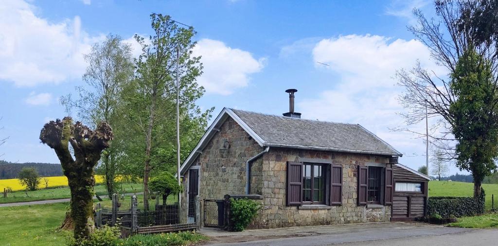 a small stone house in the middle of a field at Holliday Home La Douane in Gedinne