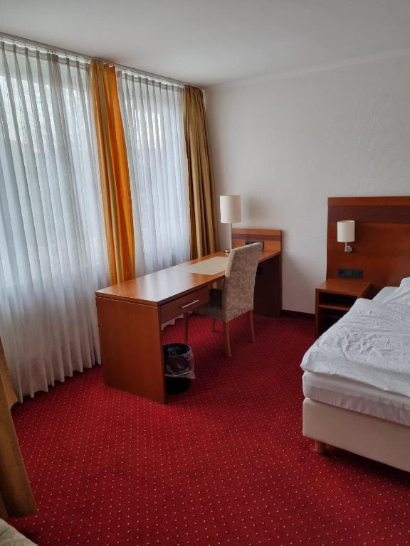 Postel nebo postele na pokoji v ubytování Hotel am Rosenpark