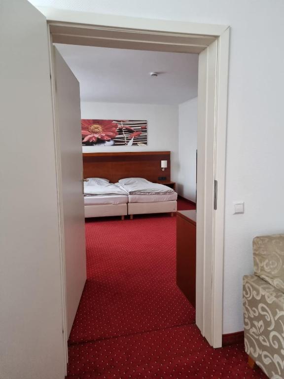 Postel nebo postele na pokoji v ubytování Hotel am Rosenpark