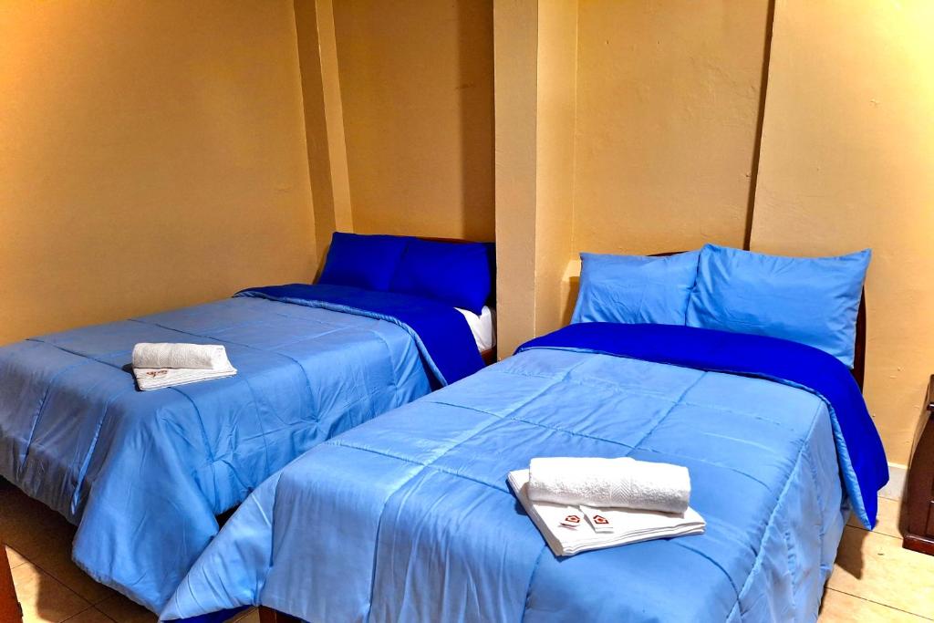 Postel nebo postele na pokoji v ubytování Travel Hotel Quito