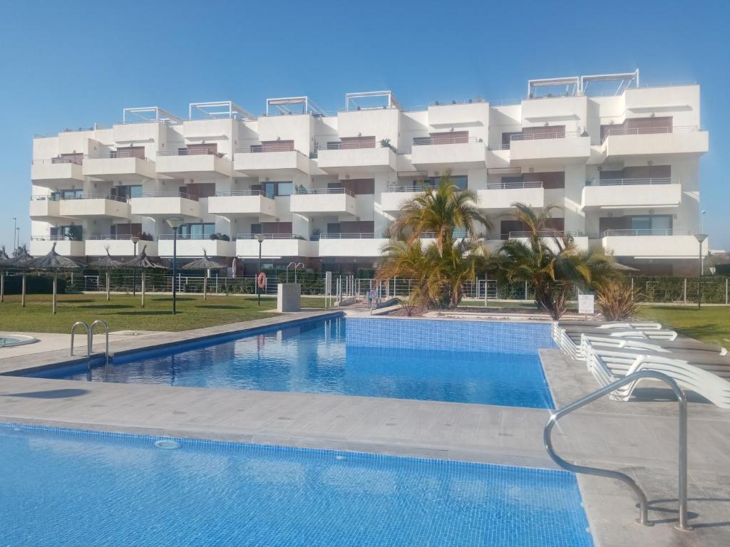 a hotel with a swimming pool in front of a building at ELIO Terrazas de Campoamor in Orihuela Costa
