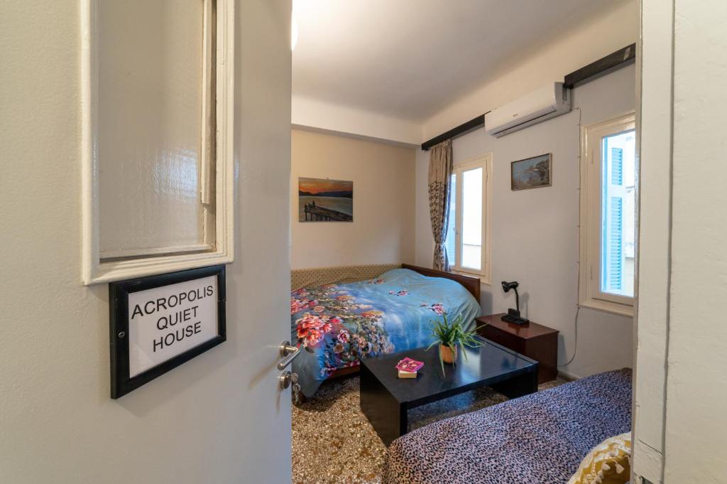 A bed or beds in a room at Acropolis Quiet House