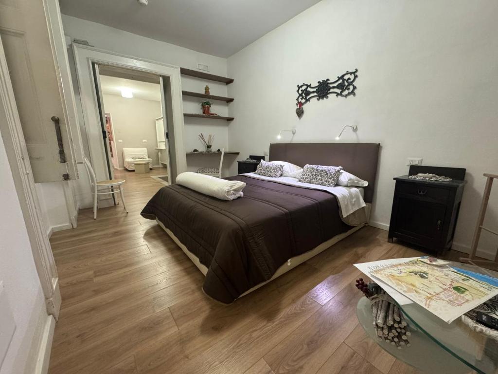 a bedroom with a large bed and a wooden floor at Donna Mariella in Naples
