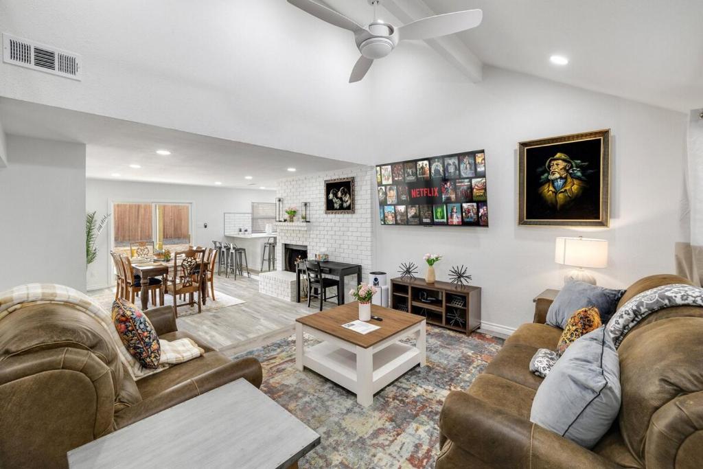 a living room with two couches and a table at Frisco Getaway Hometel w the Spa and Outdoor Kitchen in Frisco