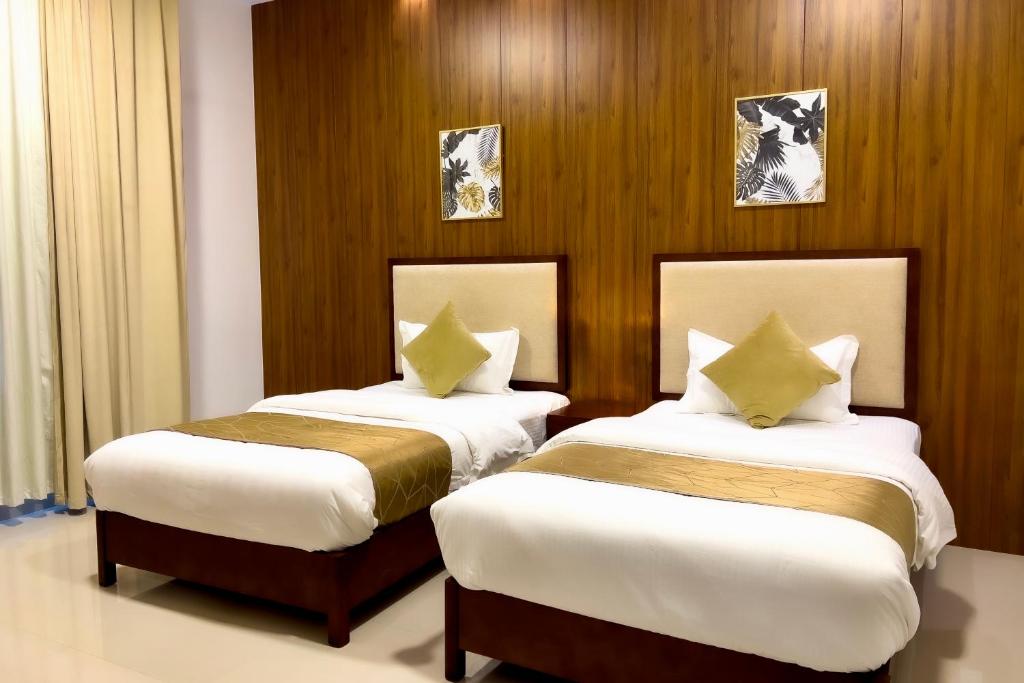 Postel nebo postele na pokoji v ubytování Daar AL Maqam Suites Apartments Salalah