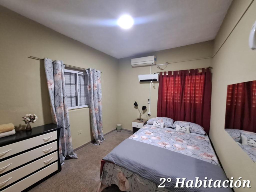 a bedroom with a bed and a dresser and a window at Alojamiento Marlumg in Corrientes