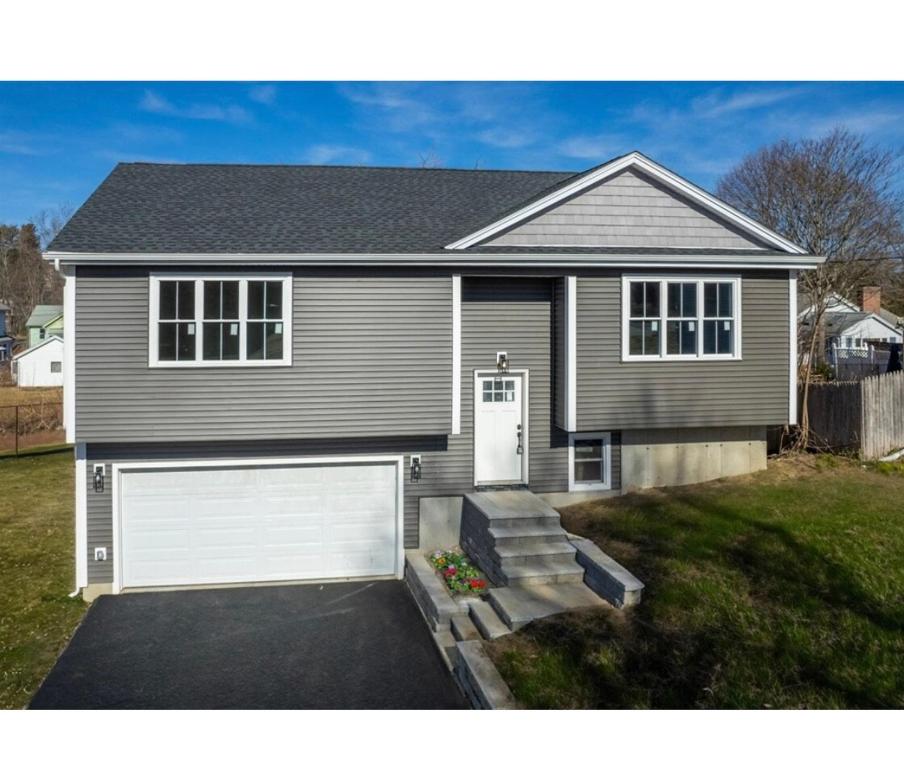 a gray house with a white garage at Brand New Fully Furnished Villa in Worcester