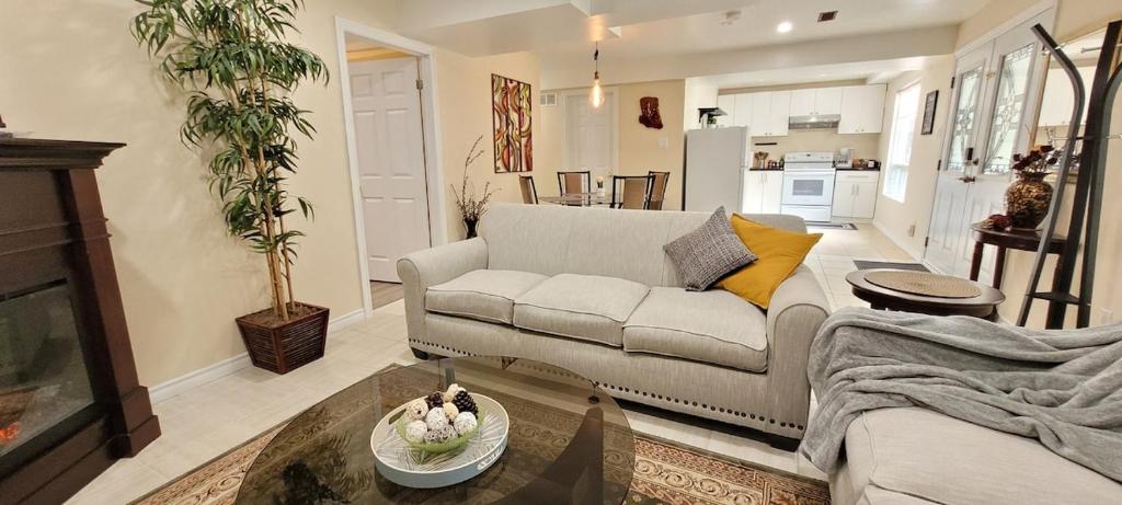 a living room with a couch and a table at Holiday Hideout Basement Unit in Pickering