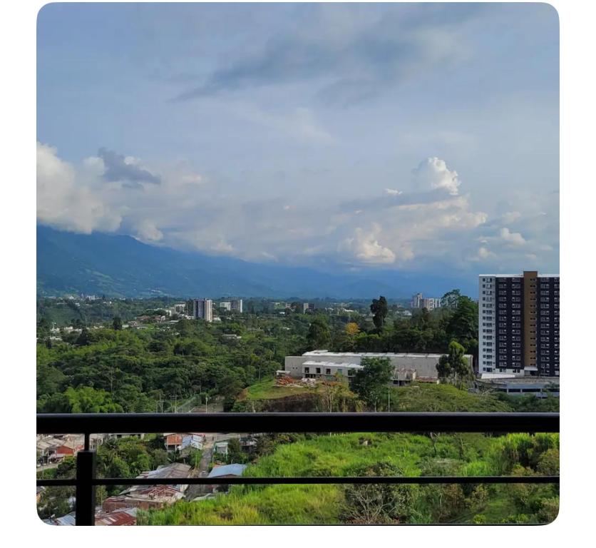 a view of a city from a balcony at David Cómodo Apartamento con Piscina in Armenia