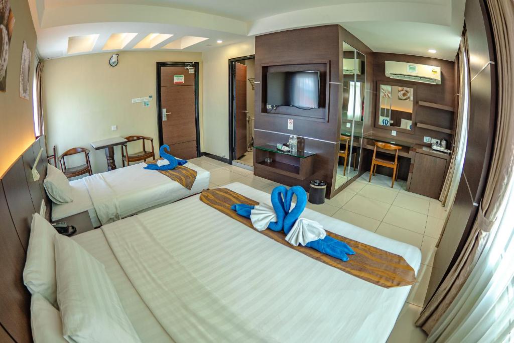 Postel nebo postele na pokoji v ubytování Wave View Hotel